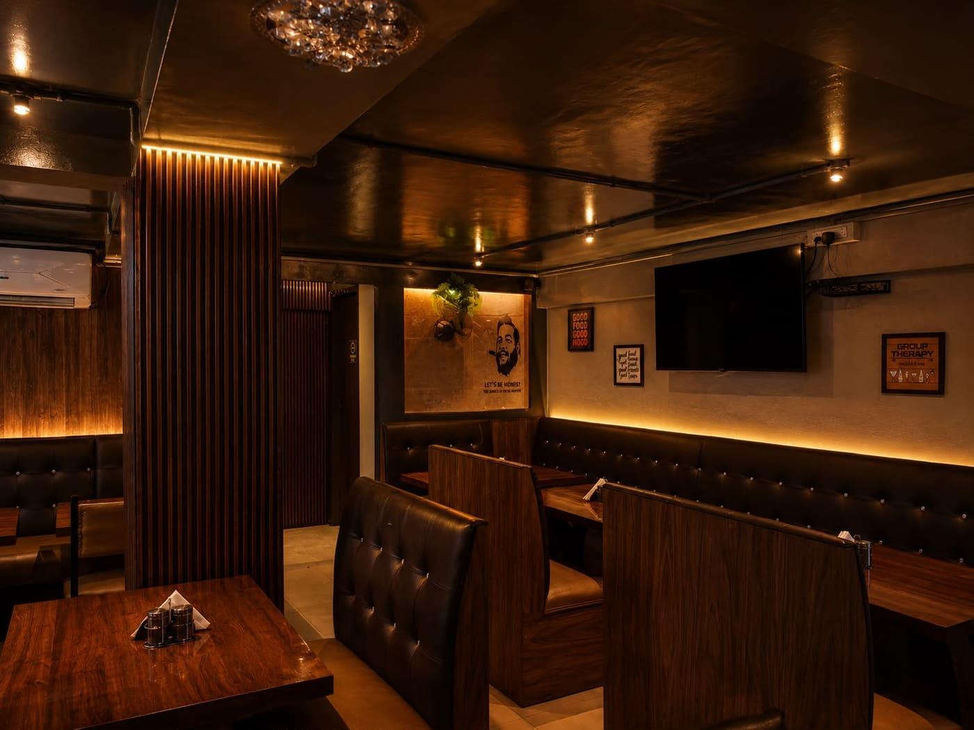 The bar counter with dark wood finishes and copper accents.